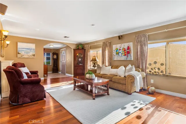 a living room with furniture rug and wooden floor