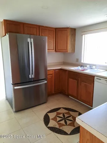 a kitchen with stainless steel appliances granite countertop a refrigerator sink and cabinets