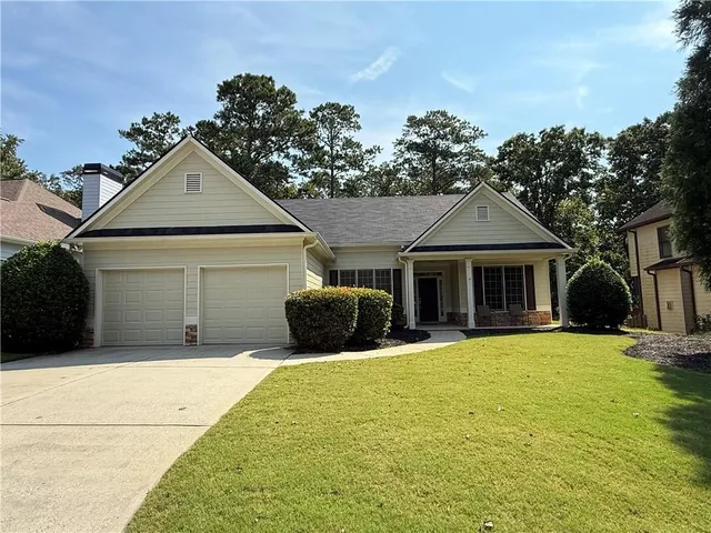 a front view of a house with yard and garage