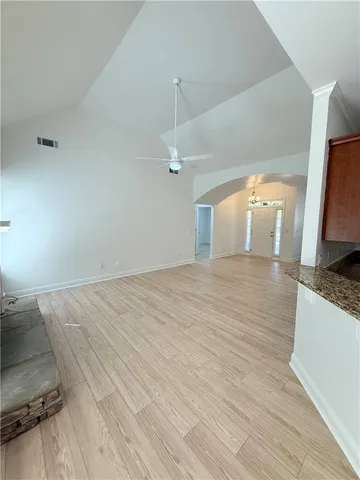 a kitchen with granite countertop a sink a counter space and cabinets