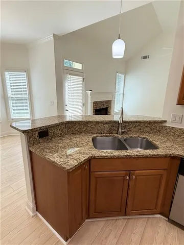 a large kitchen with stainless steel appliances granite countertop a sink stove and refrigerator