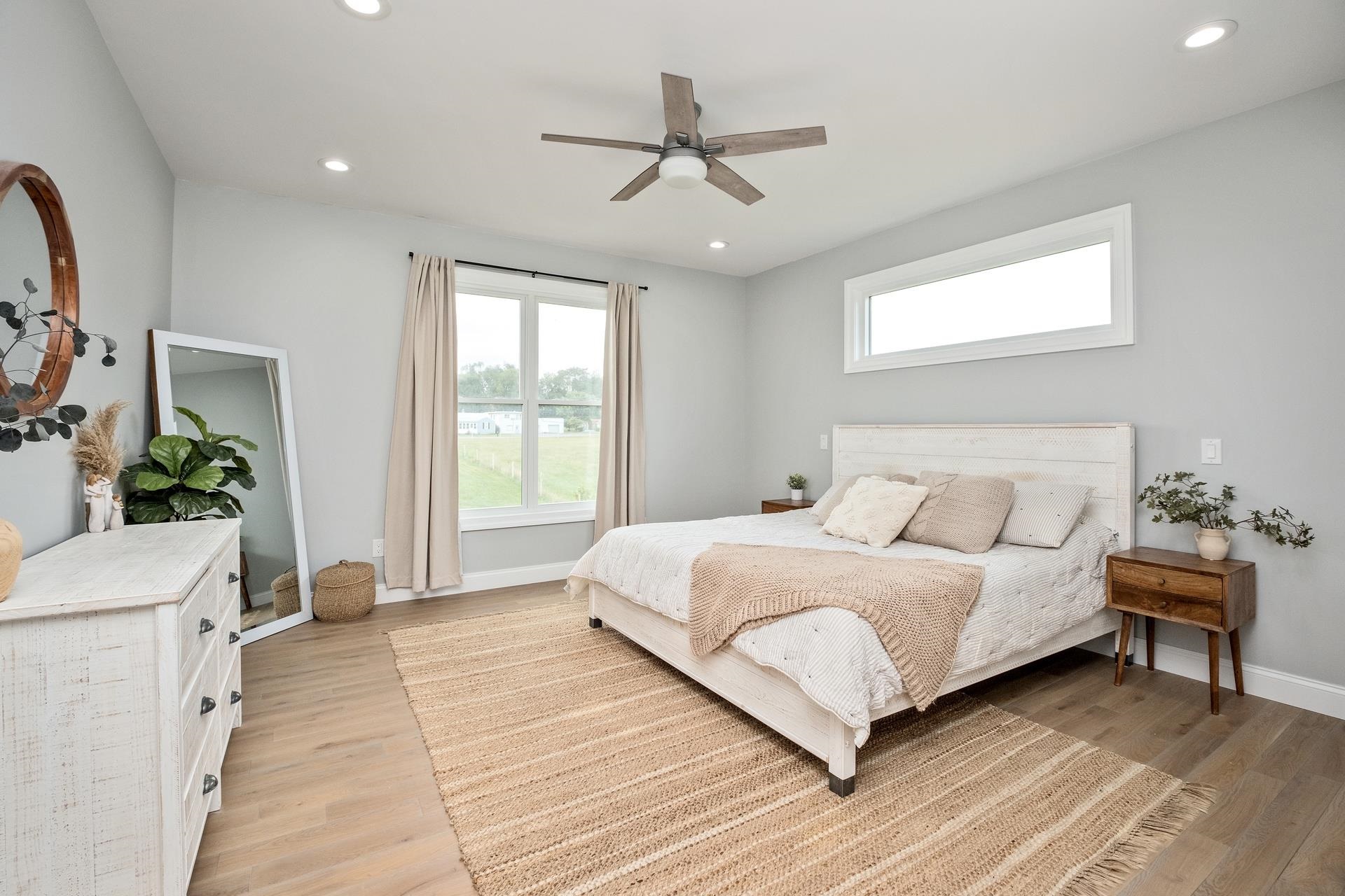 303 Bartley Street Dayton, VA 22821 - Photo 20 of 47 a bedroom with a large bed and a chandelier
