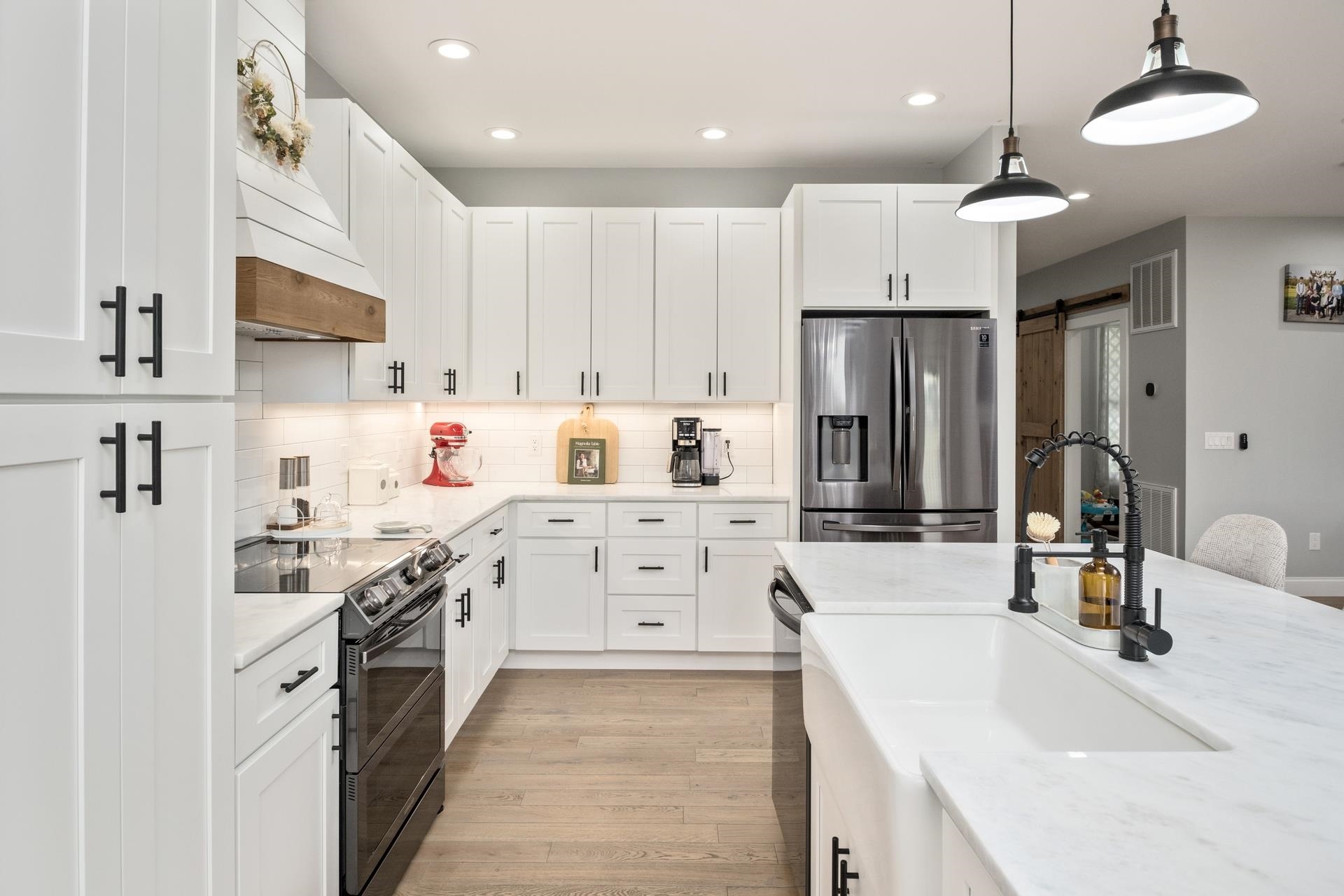 303 Bartley Street Dayton, VA 22821 - Photo 7 of 47 a kitchen with white cabinets and stainless steel appliances