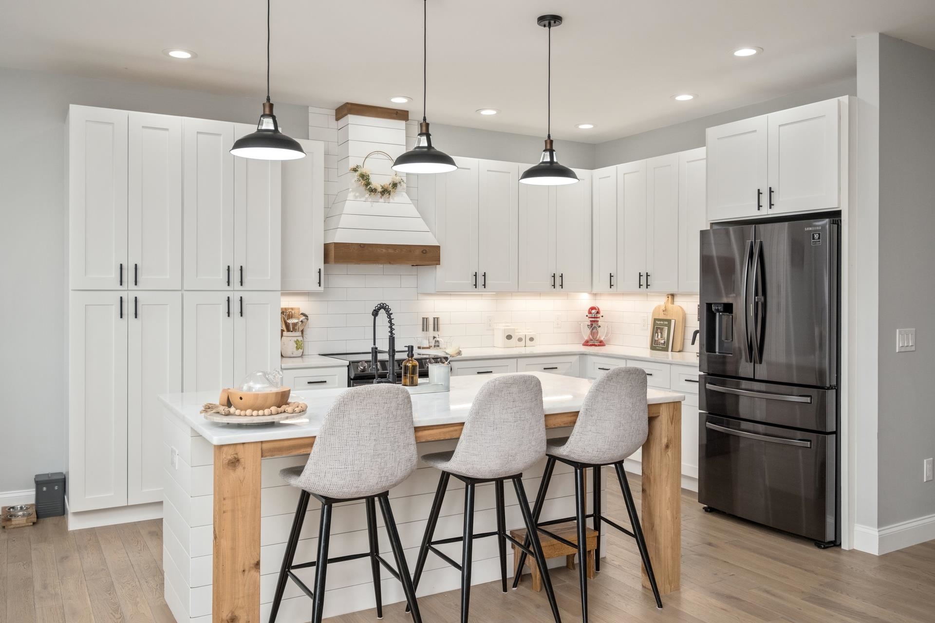 303 Bartley Street Dayton, VA 22821 - Photo 10 of 47 a kitchen with stainless steel appliances granite countertop a refrigerator a sink a stove a refrigerator and chairs with wooden floor