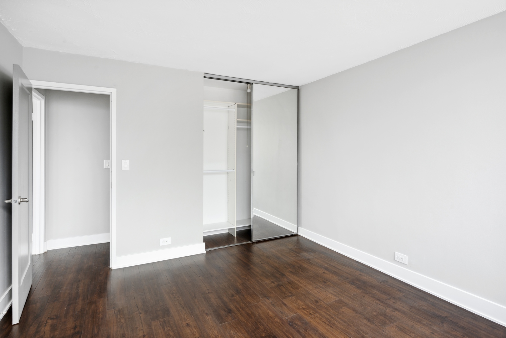 5601 North Sheridan Road, Unit 21E Chicago, IL 60660 - Photo 17 of 27 a view of an empty room with wooden floor