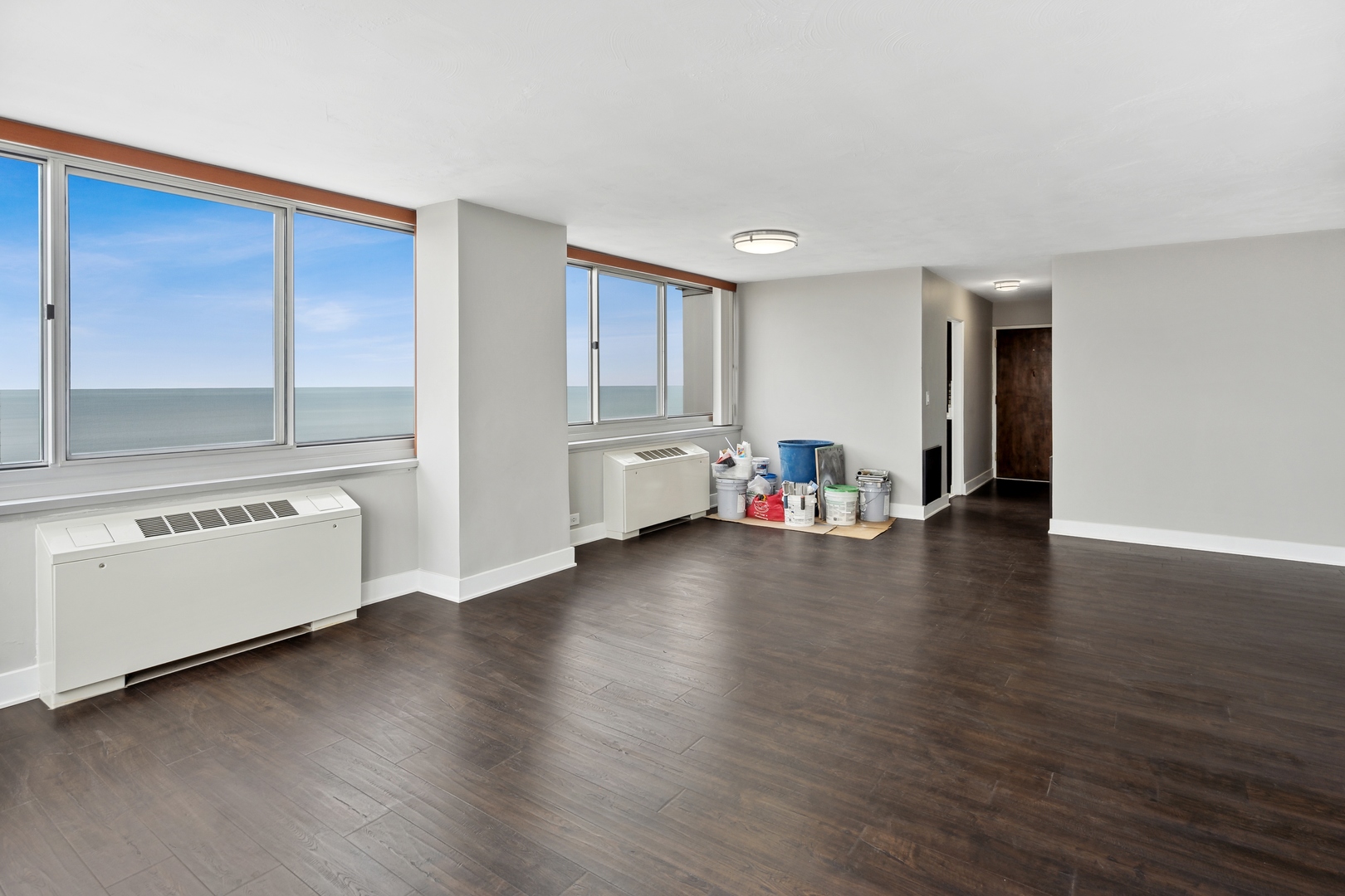 5601 North Sheridan Road, Unit 21E Chicago, IL 60660 - Photo 5 of 27 a view of empty room with wooden floor and window