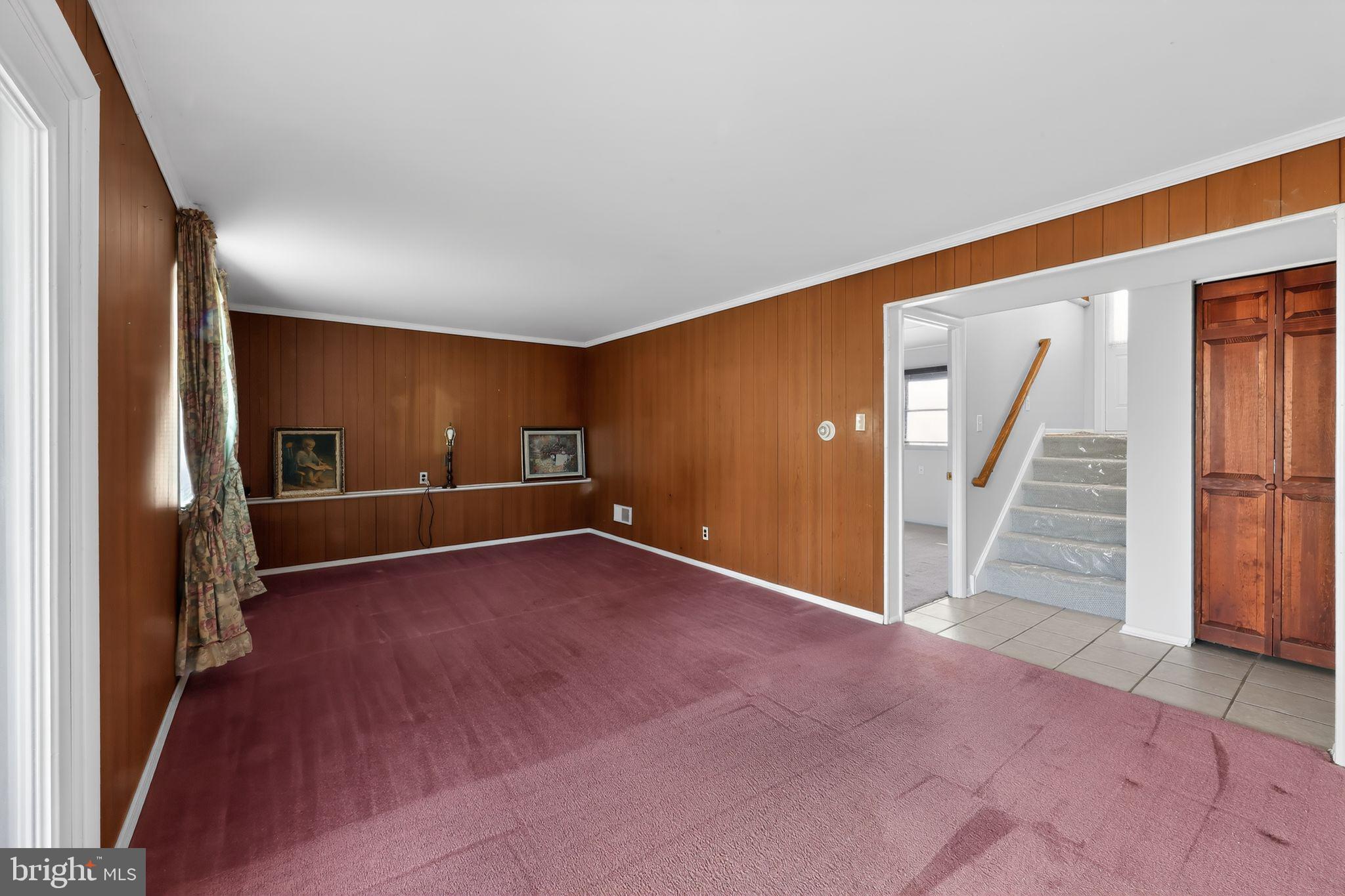 214 Bluefield Road Newark, DE 19713 - Photo 20 of 28 an empty room with wooden floor staircase and windows