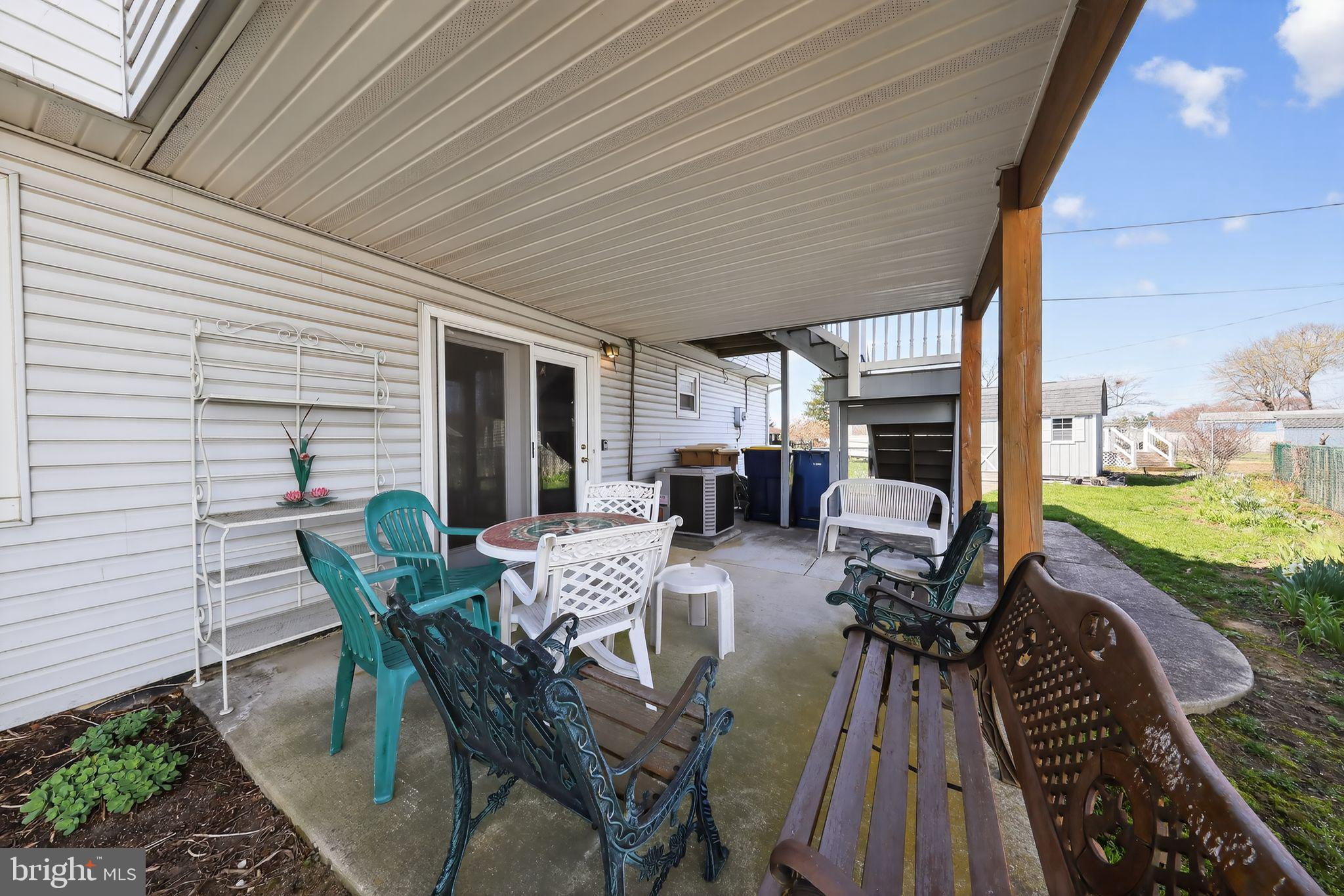 214 Bluefield Road Newark, DE 19713 - Photo 26 of 28 a view of a patio with table and chairs potted plants with floor to ceiling window