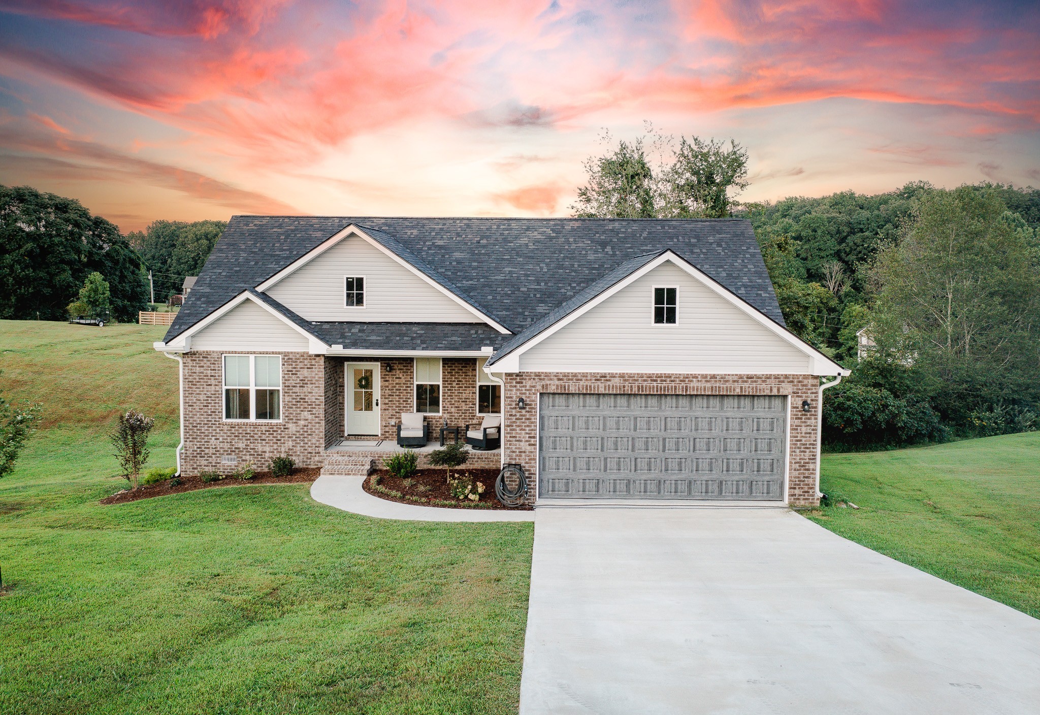 a front view of house with yard and green space