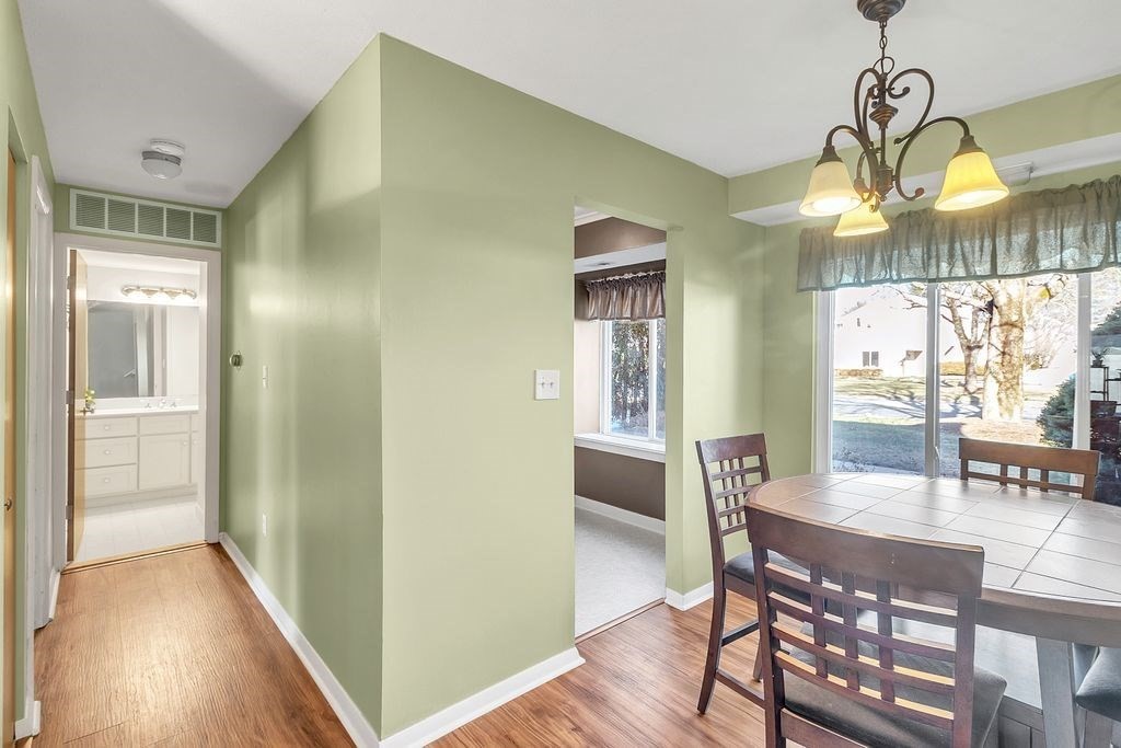 103 Nassau Drive, Unit 103 Springfield, MA 01129 - Photo 13 of 25 a view of a dining room with furniture window and wooden floor