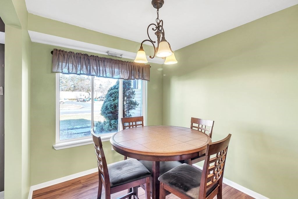 103 Nassau Drive, Unit 103 Springfield, MA 01129 - Photo 14 of 25 a view of a dining room with furniture window and wooden floor