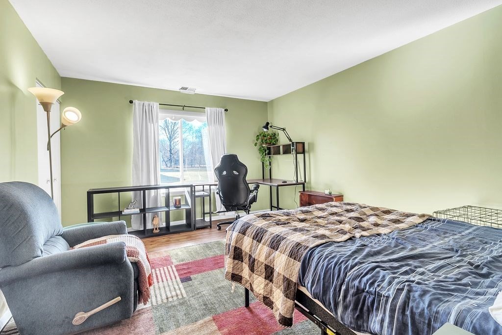 103 Nassau Drive, Unit 103 Springfield, MA 01129 - Photo 18 of 25 a bedroom with a bed a couch and dresser