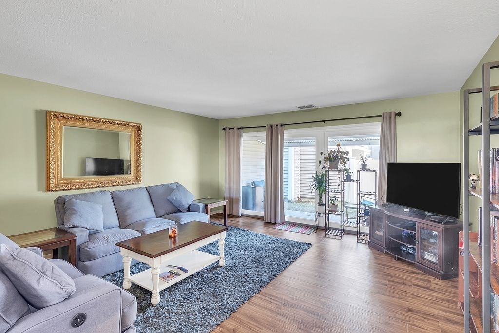 103 Nassau Drive, Unit 103 Springfield, MA 01129 - Photo 2 of 25 a living room with furniture and a flat screen tv