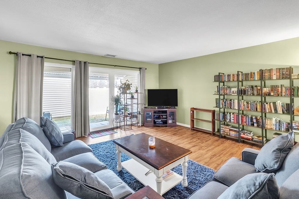 103 Nassau Drive, Unit 103 Springfield, MA 01129 - Photo 3 of 25 a living room with furniture and a flat screen tv