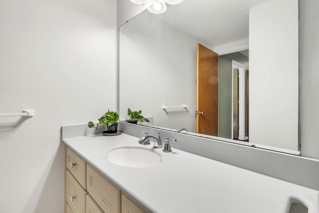 103 Nassau Drive, Unit 103 Springfield, MA 01129 - Photo 5 of 25 a bathroom with a sink and a mirror