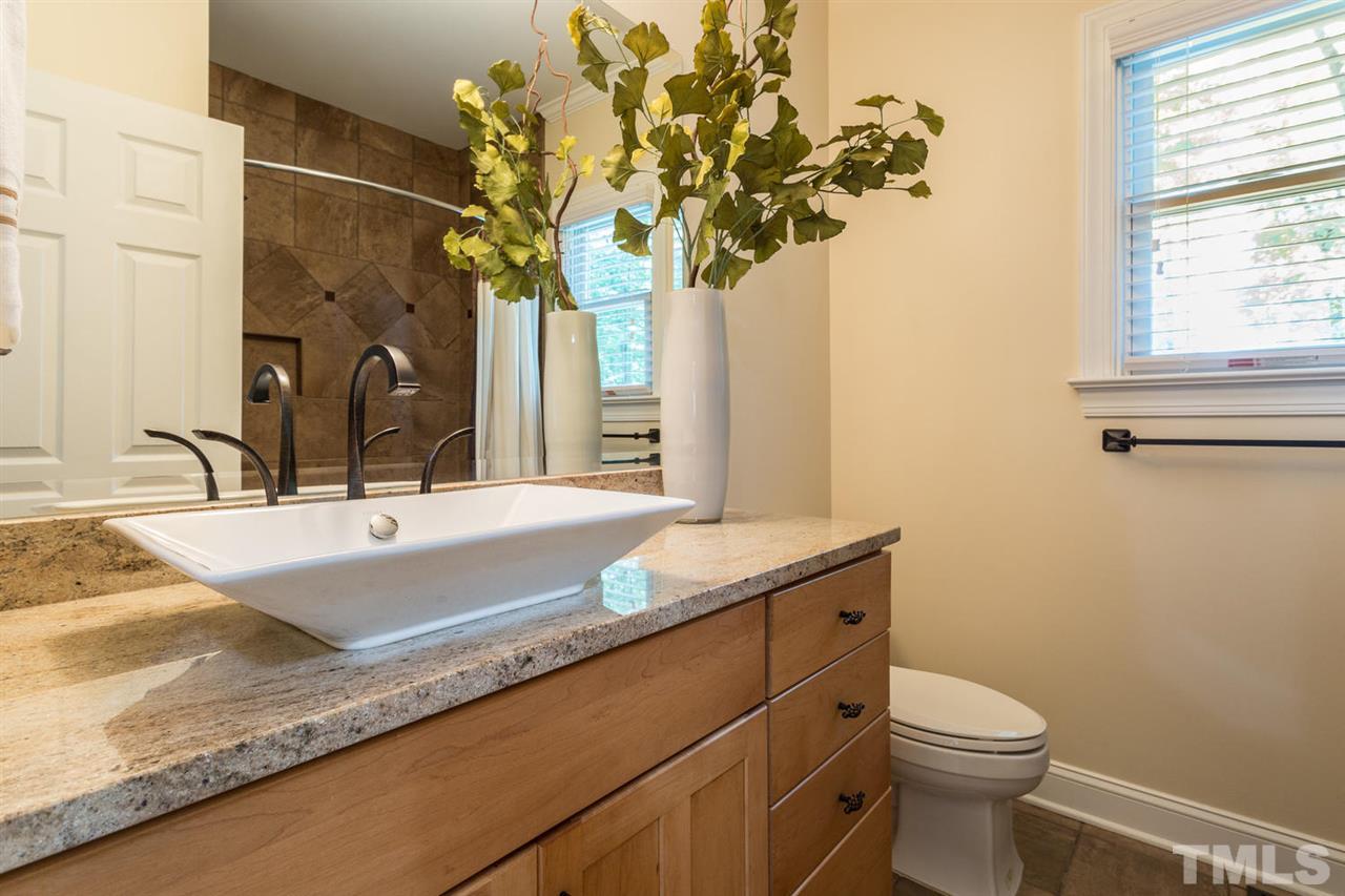 2537 Mt Vernon Church Road Raleigh, NC 27614 - Photo 20 of 30 a bathroom with a granite countertop sink a large mirror and a toilet