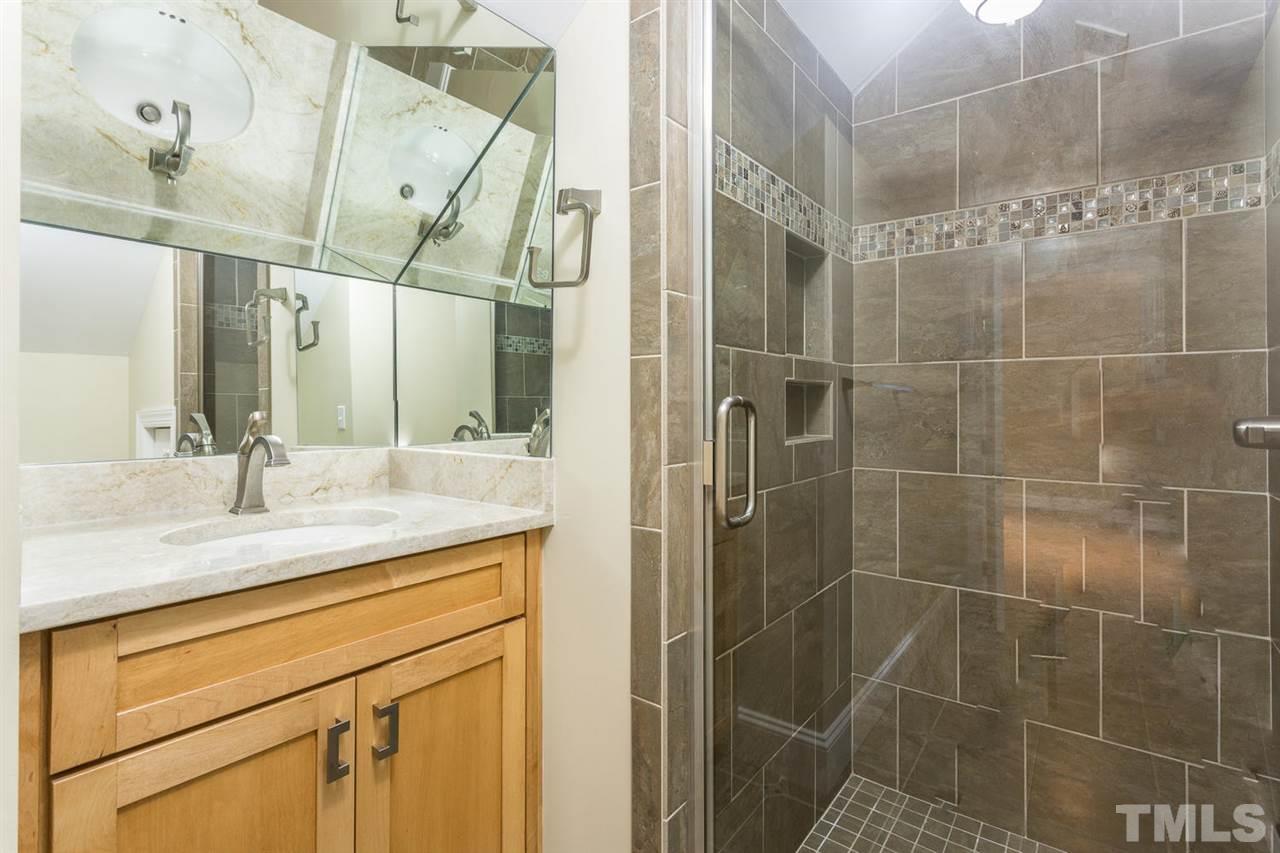 2537 Mt Vernon Church Road Raleigh, NC 27614 - Photo 22 of 30 a bathroom with a granite countertop sink a mirror and shower