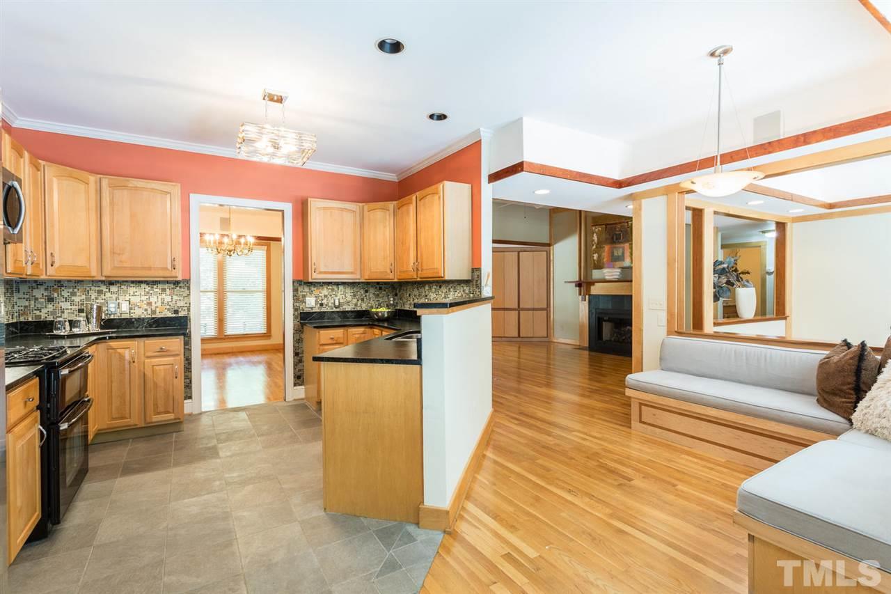 2537 Mt Vernon Church Road Raleigh, NC 27614 - Photo 10 of 30 a kitchen with stainless steel appliances granite countertop a refrigerator a sink dishwasher a stove and white cabinets with wooden floor