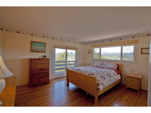 2995 Ribera Road Carmel, CA 93923 - Photo 13 of 16 a bedroom with a bed window and a dresser