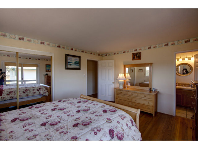 2995 Ribera Road Carmel, CA 93923 - Photo 14 of 16 a bedroom with a bed and wooden floor