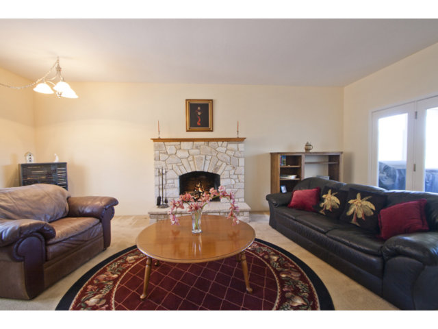 2995 Ribera Road Carmel, CA 93923 - Photo 3 of 16 a living room with furniture a fireplace and a dining table