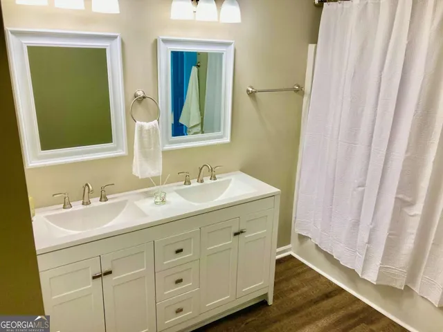 a bathroom with a double vanity sink and a mirror