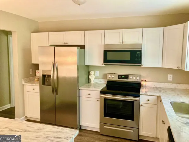 a kitchen with a stove microwave and refrigerator