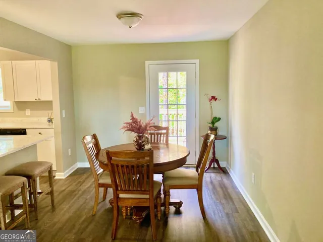 a view of a dining room with furniture and wooden floor
