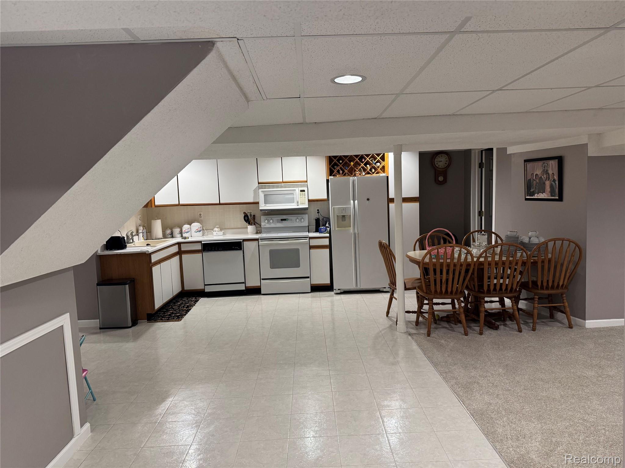 48583 Tilch Road Macomb, MI 48044 - Photo 43 of 53 Kitchen featuring light countertops, white appliances, dual tone cabinetry, and a paneled ceiling