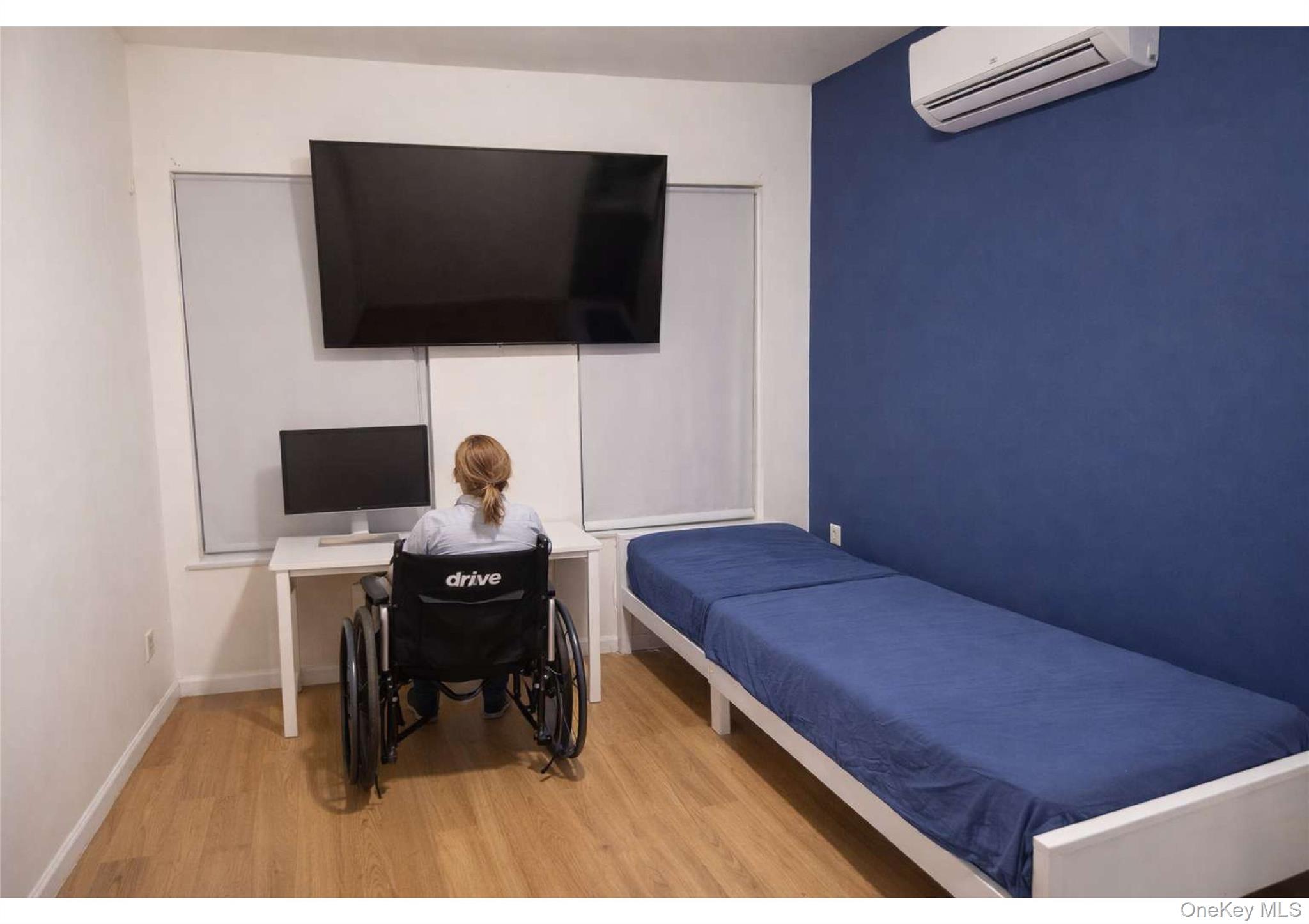 85-40 79th Street Queens, NY 11421 - Photo 11 of 19 Bedroom featuring light wood-style flooring, an AC wall unit, and a desk