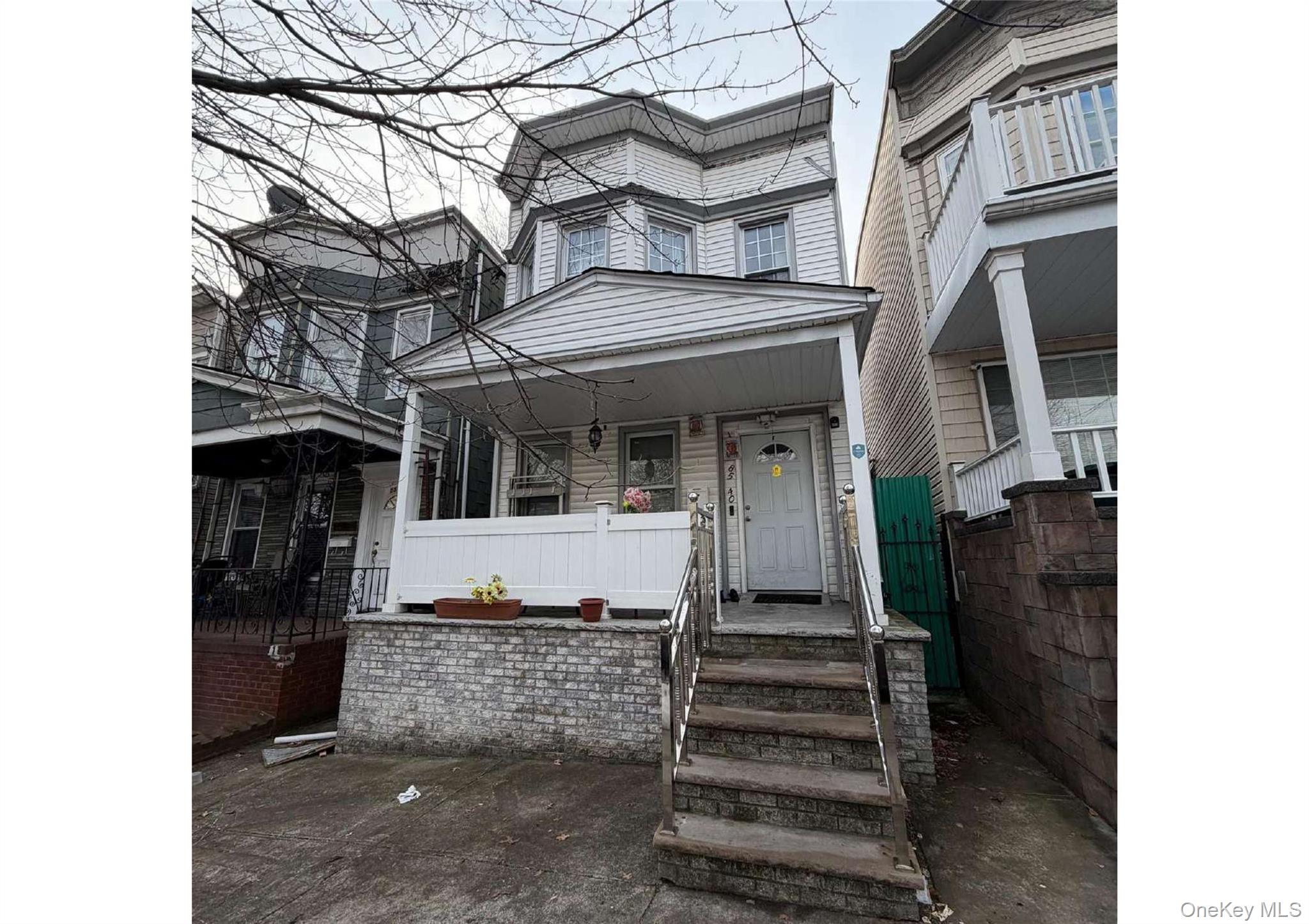 85-40 79th Street Queens, NY 11421 - Photo 3 of 19 View of front of house with a porch