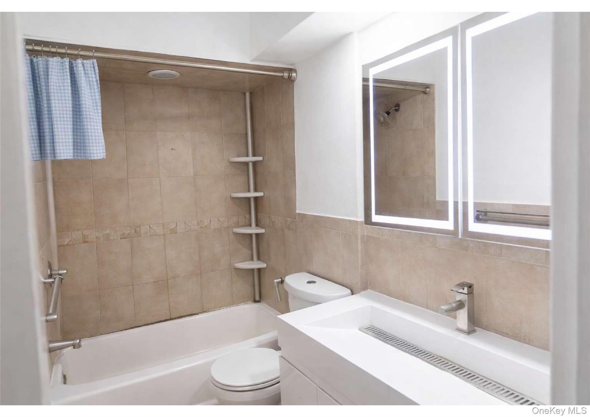 85-40 79th Street Queens, NY 11421 - Photo 4 of 19 Bathroom with shower / bathtub combination, vanity, and tile walls