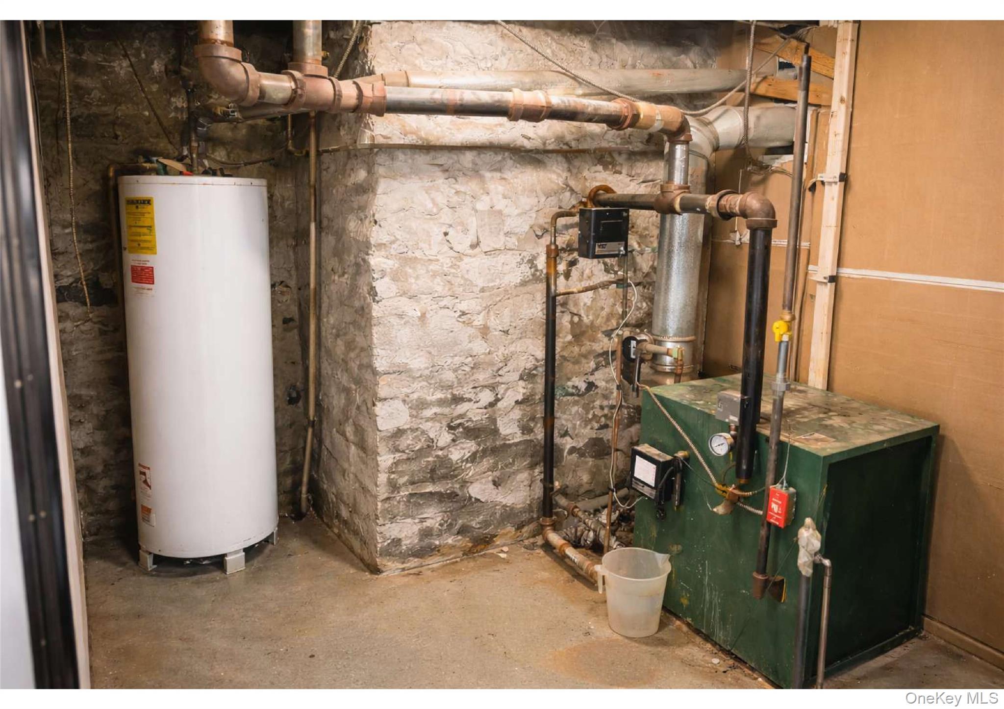 85-40 79th Street Queens, NY 11421 - Photo 7 of 19 Utilities with water heater and a heating unit