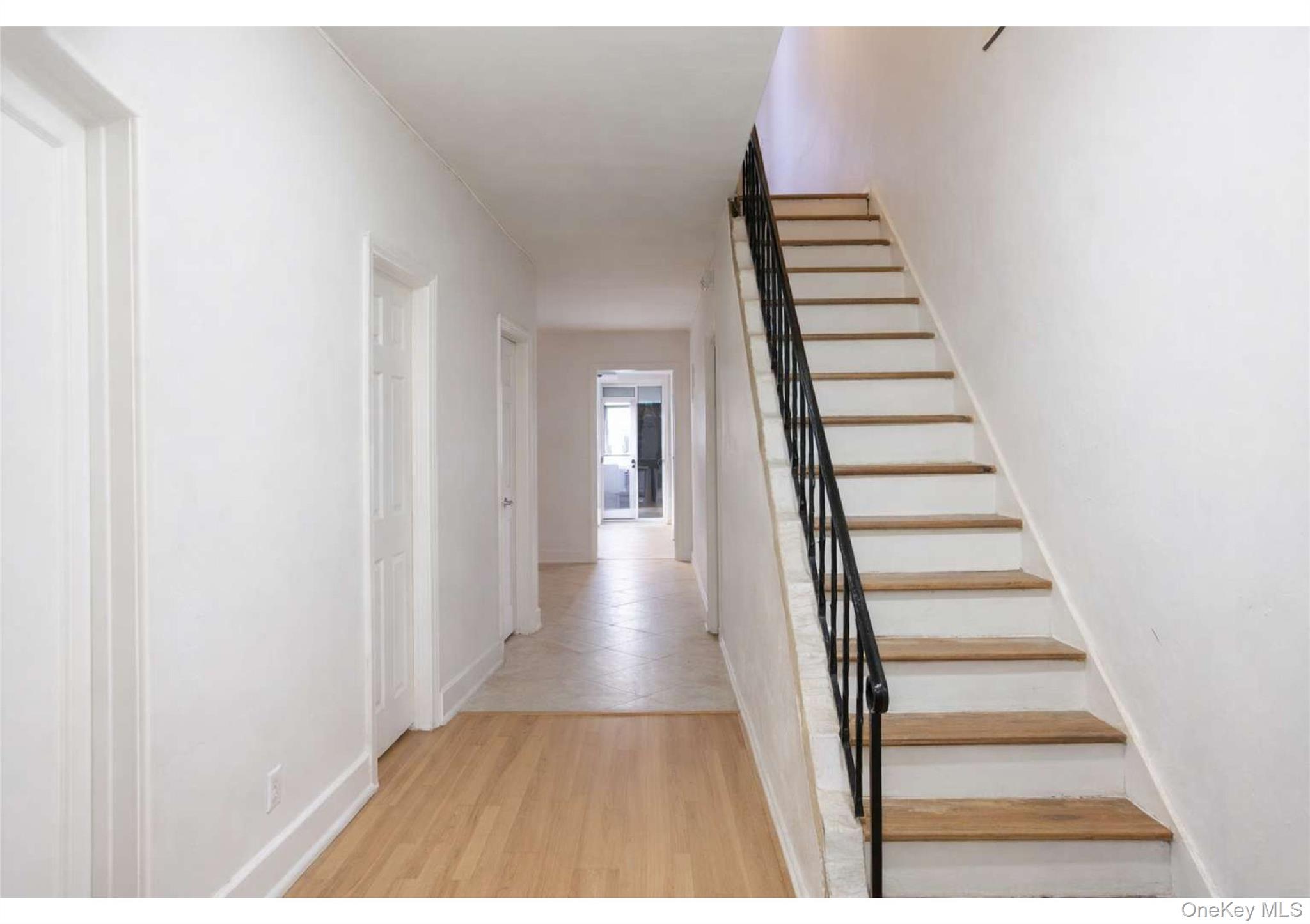 85-40 79th Street Queens, NY 11421 - Photo 9 of 19 Stairs featuring wood finished floors and baseboards