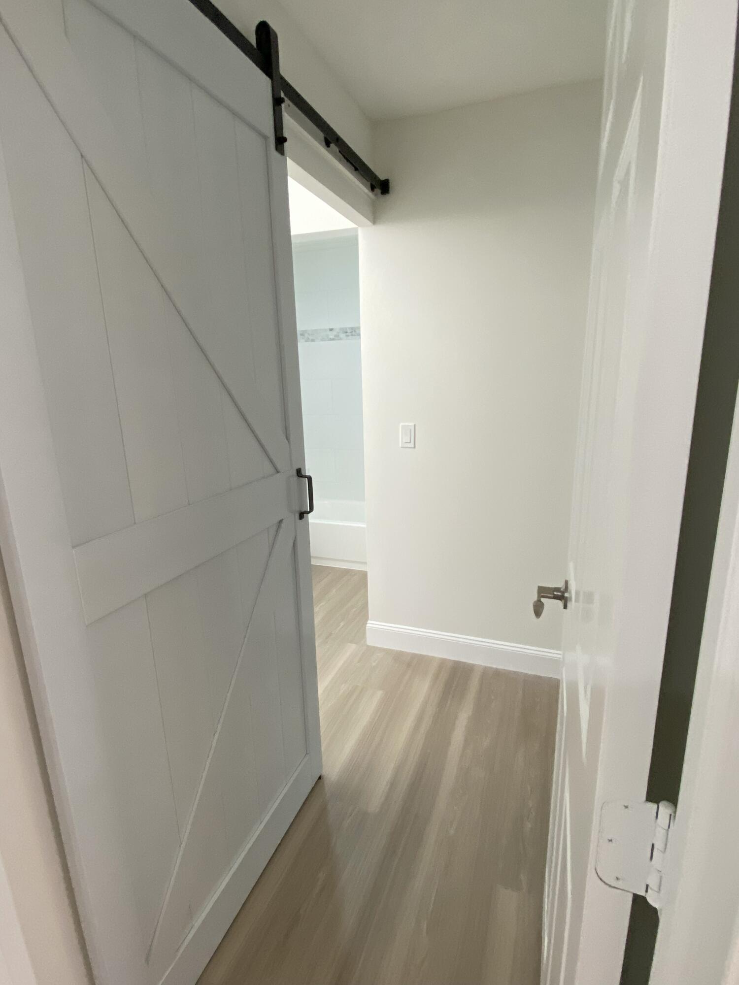 17389 63rd Road North Loxahatchee, FL 33470 - Photo 15 of 25 Barn door to primary bathroom