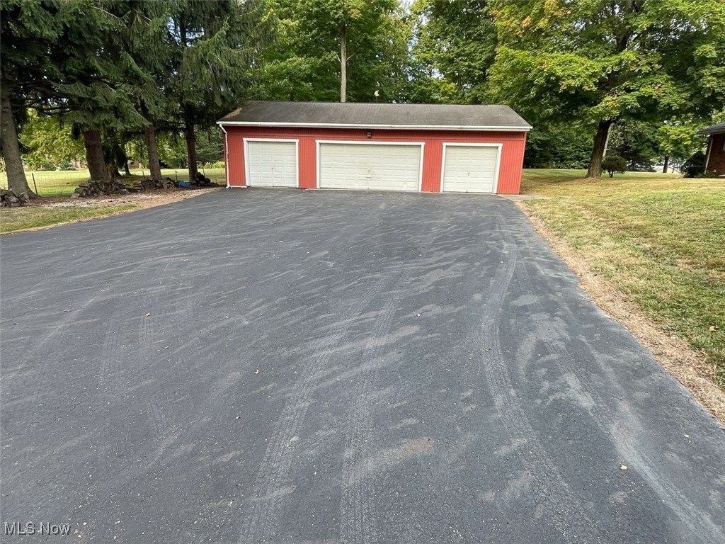 5990 Meese Road Northeast Louisville, OH 44641 - Photo 7 of 16 Detached garage with view of scattered trees