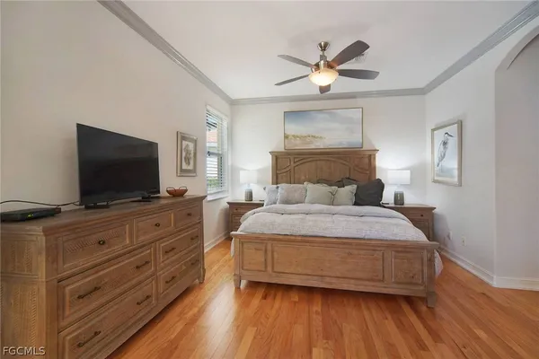 a bedroom with a large bed and a flat screen tv