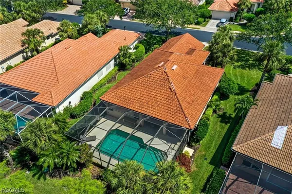 an aerial view of a house with garden space and street view
