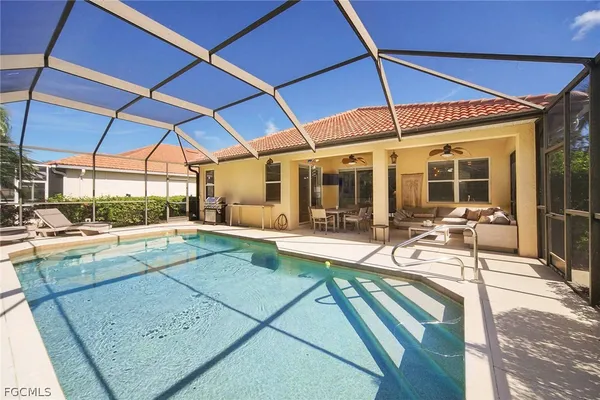 a view of a patio with a table and chairs under an umbrella