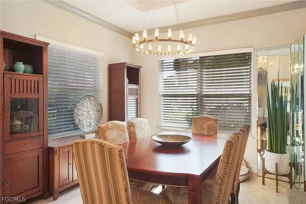 a view of a dining room with furniture and chandelier