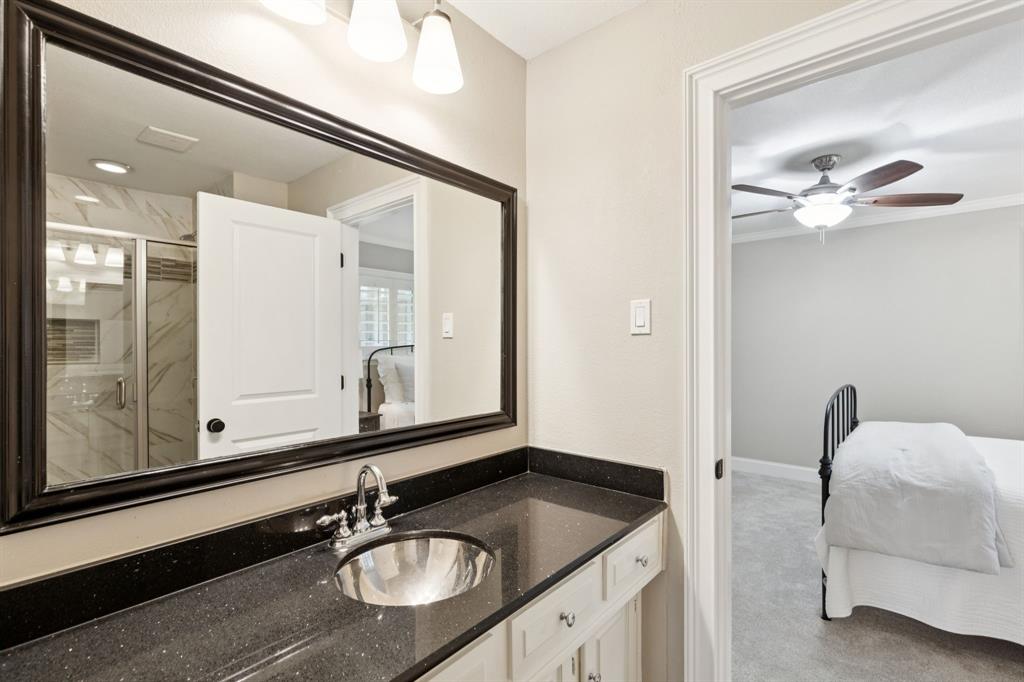 14420 Overview Drive Dallas, TX 75254 - Photo 31 of 35 a bathroom with a granite countertop sink a mirror and shower