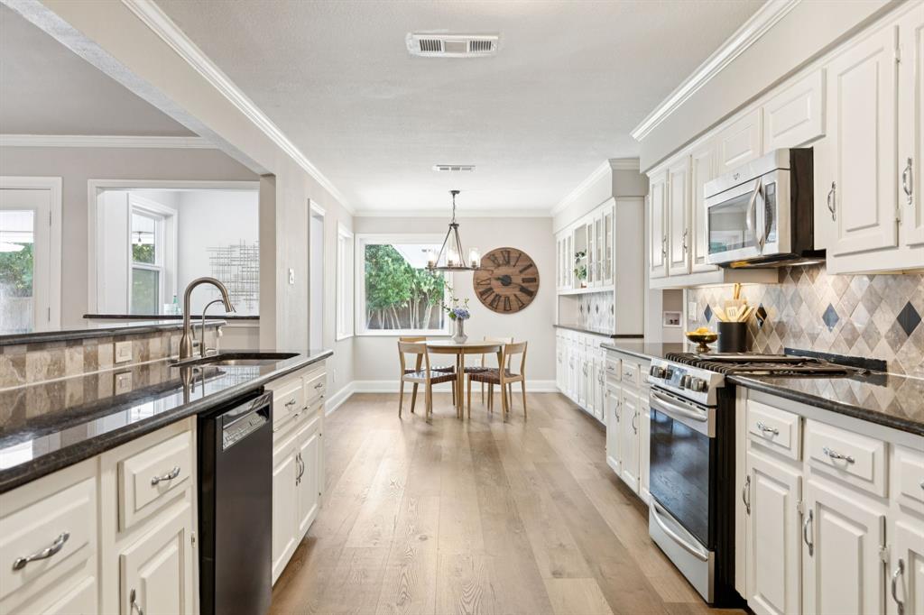 14420 Overview Drive Dallas, TX 75254 - Photo 7 of 35 a kitchen with stainless steel appliances granite countertop a stove and a sink