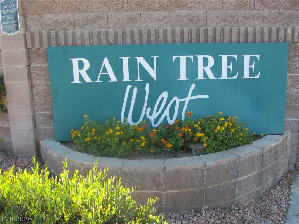7950 West Flamingo Road, Unit 2048 Las Vegas, NV 89147 - Photo 2 of 24 A welcoming sign featuring lush landscaping and a sturdy stone wall entry.