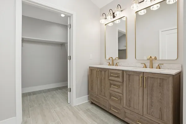 a bathroom with a double vanity sink mirror and