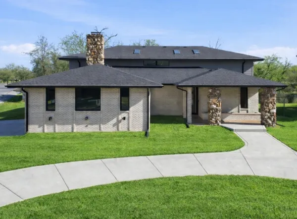 a front view of a house with a garden