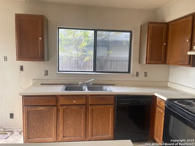 a kitchen with a sink stove and cabinets