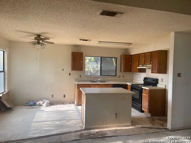 a kitchen with a stove and a sink