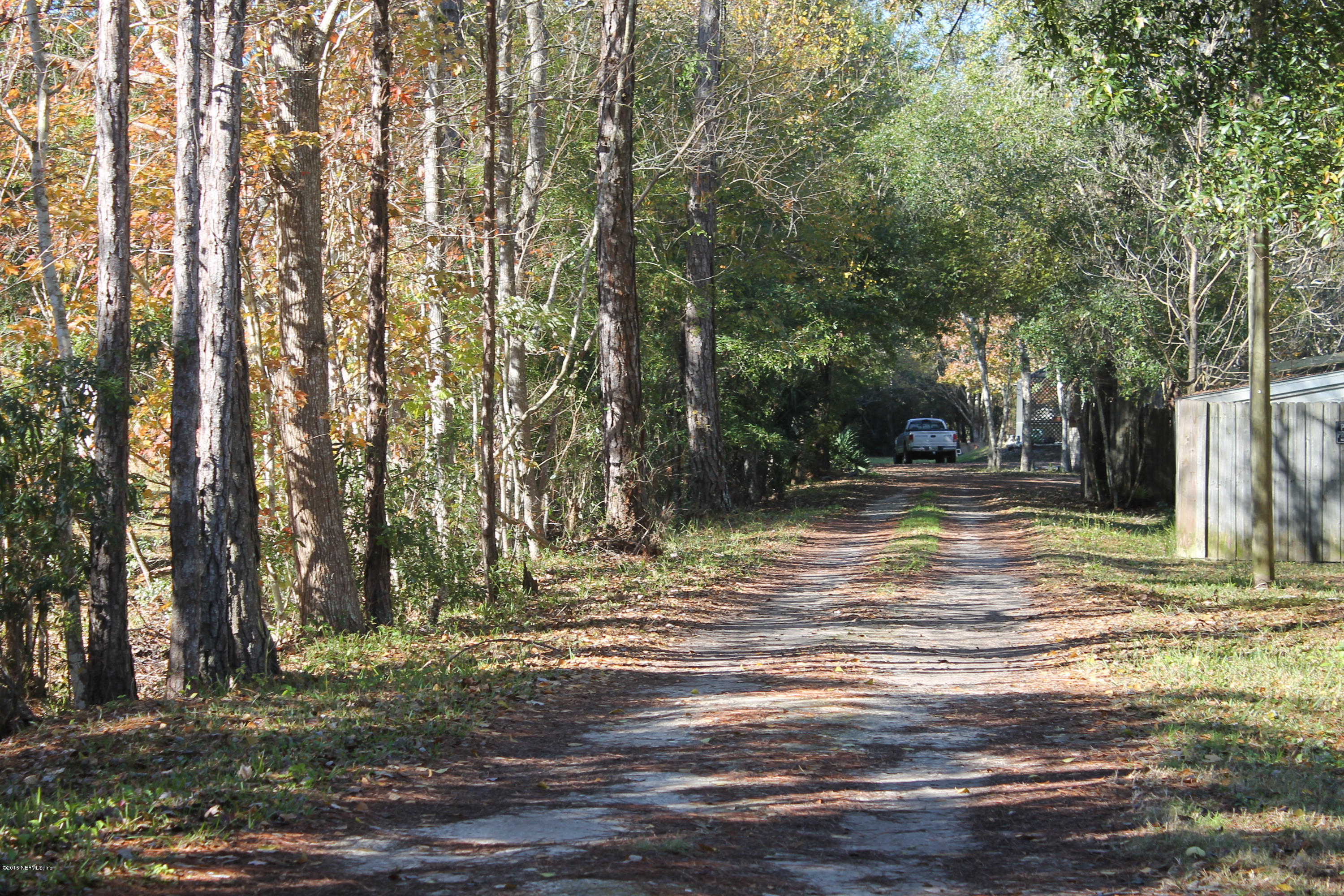 5697 Datil Pepper Road St. Augustine, FL 32086 - Photo 1 of 16 a view of a yard with a tree