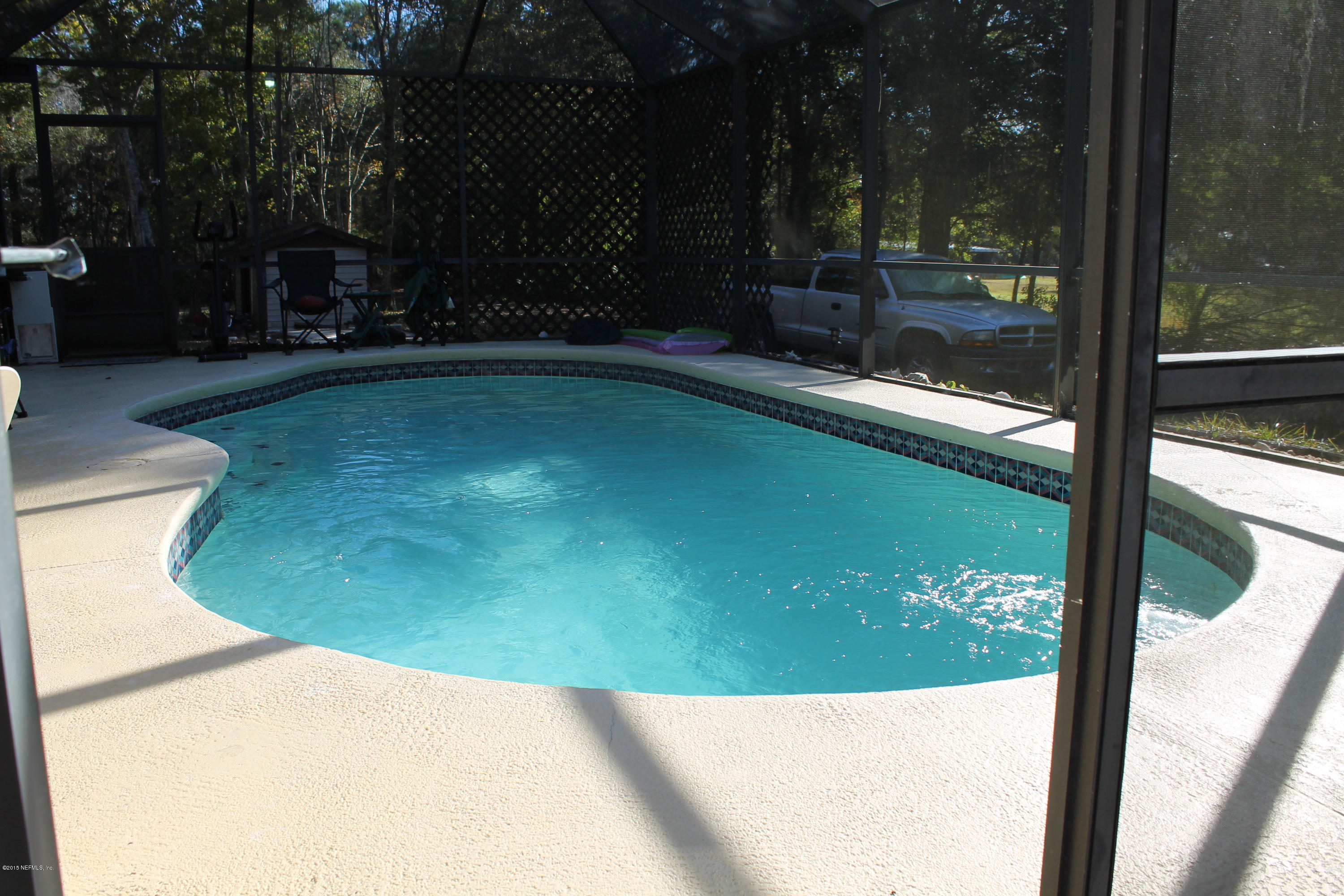 5697 Datil Pepper Road St. Augustine, FL 32086 - Photo 6 of 16 a view of a swimming pool with a bench in patio