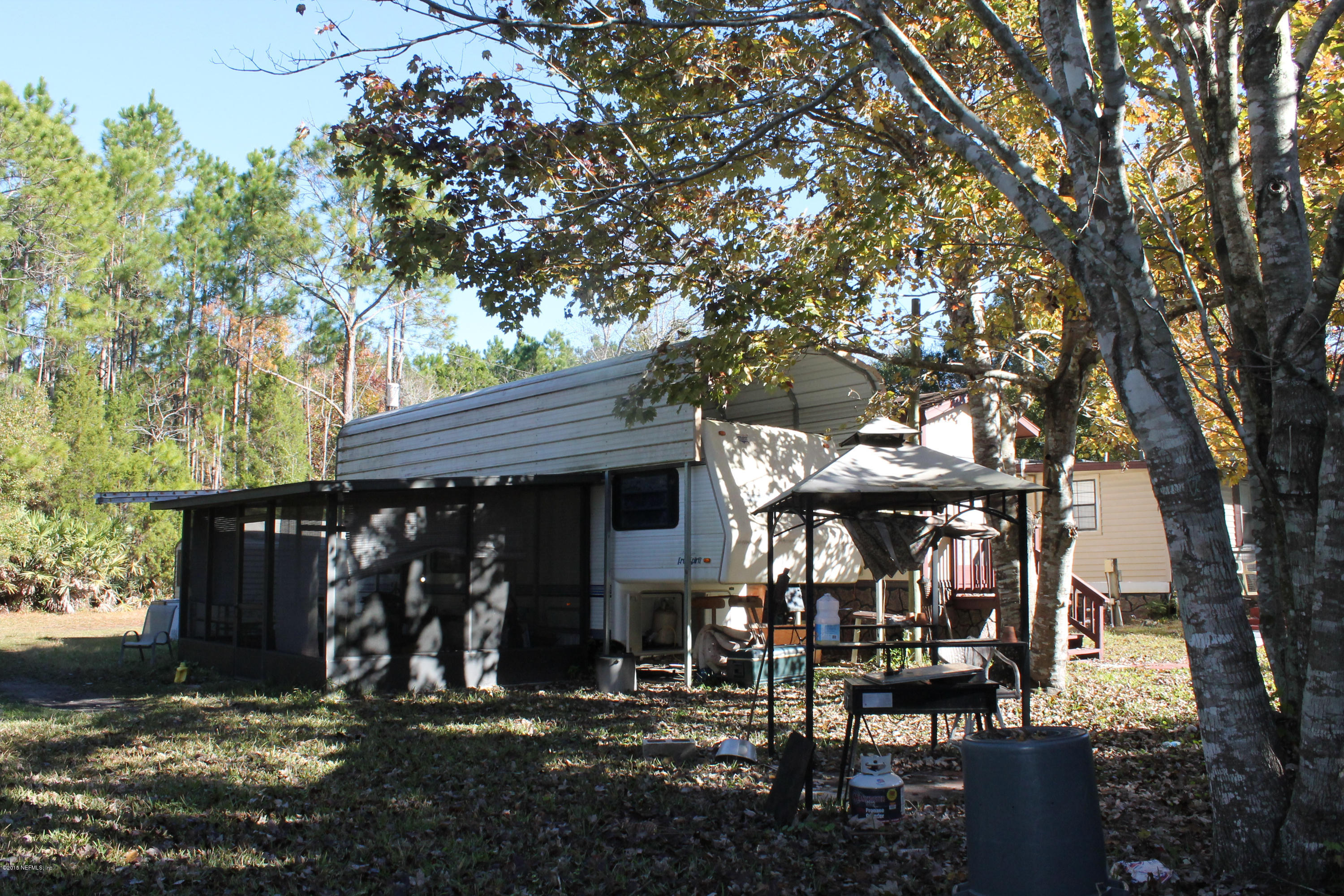 5697 Datil Pepper Road St. Augustine, FL 32086 - Photo 10 of 16 a view of a house with backyard porch and sitting area